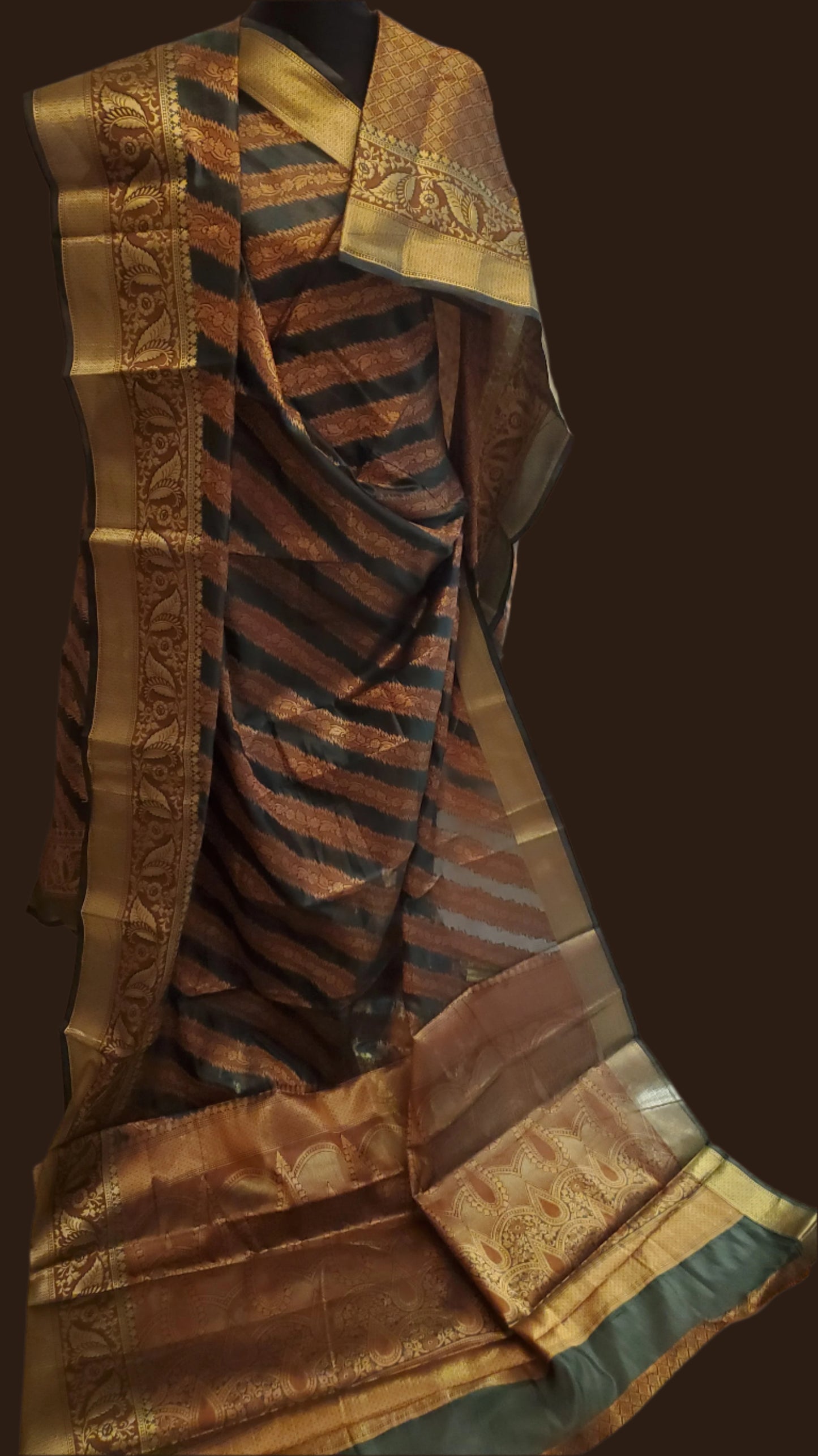 Striped fabric with gold and green patterns on a white surface