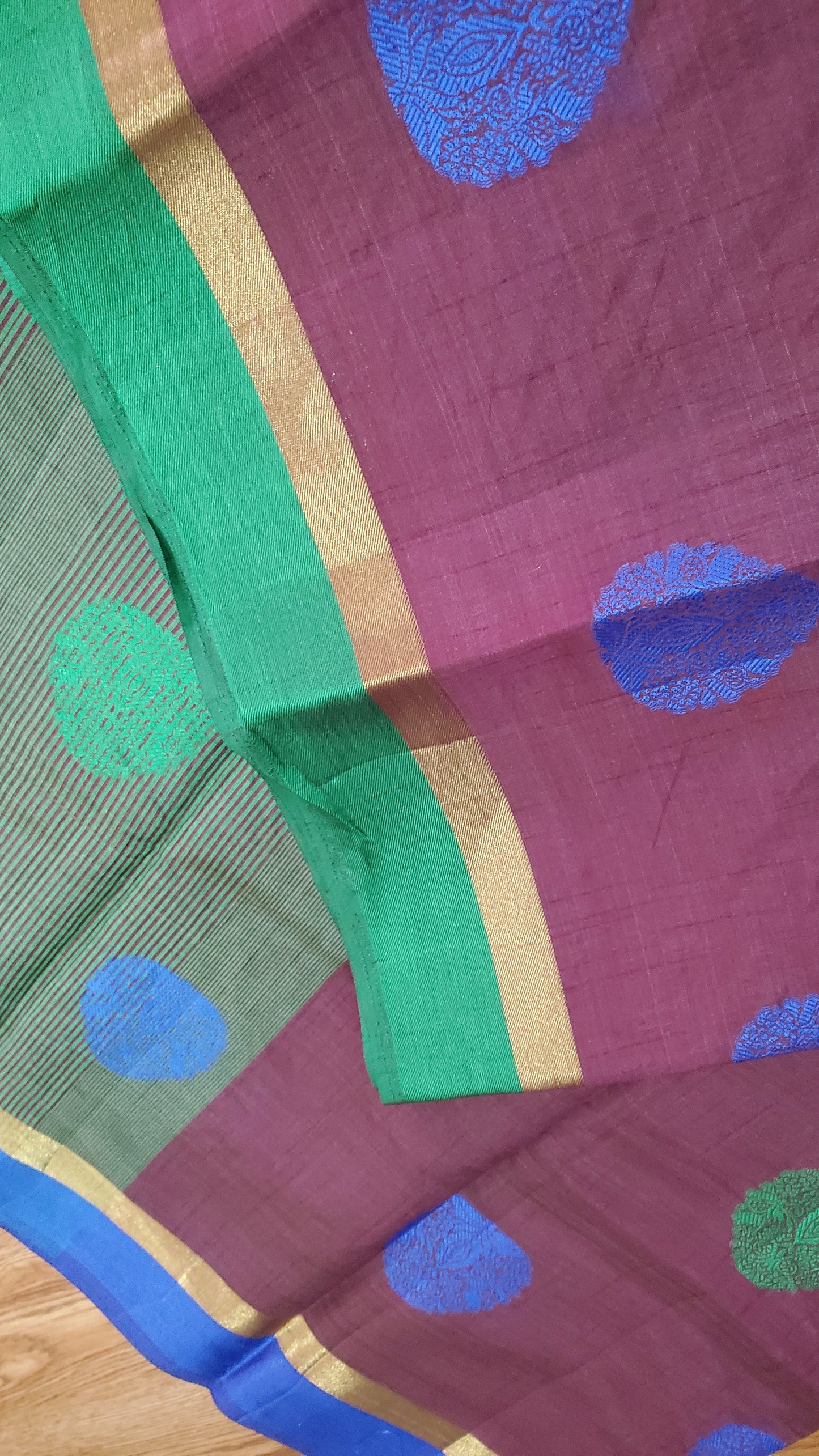 Saree with green and blue polka dots on a purple background