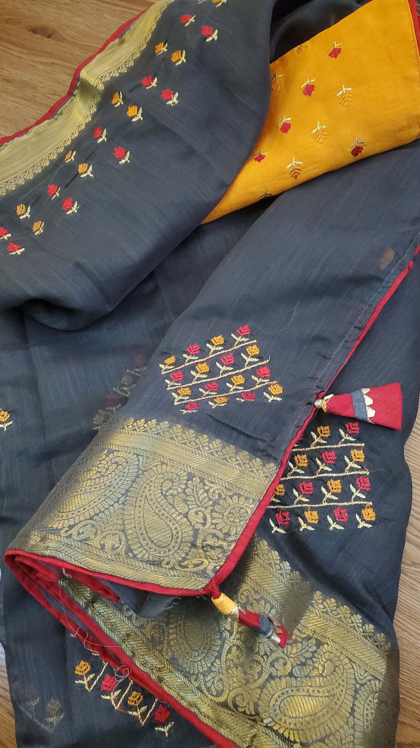 Embroidered fabric with intricate patterns on a wooden surface