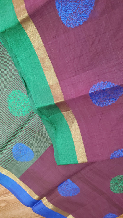 Saree with green and blue polka dots on a purple background