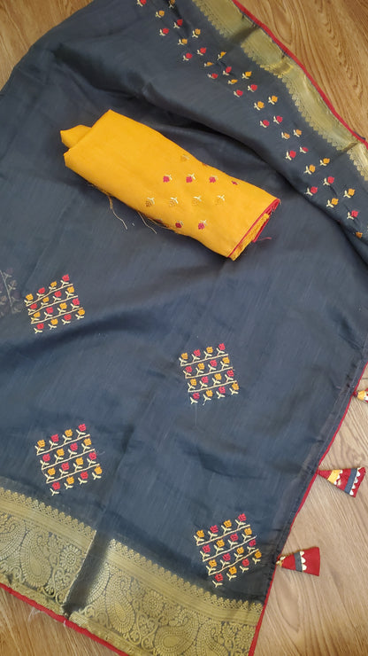 black silk saree with colorful patterns and a yellow color blouse piece