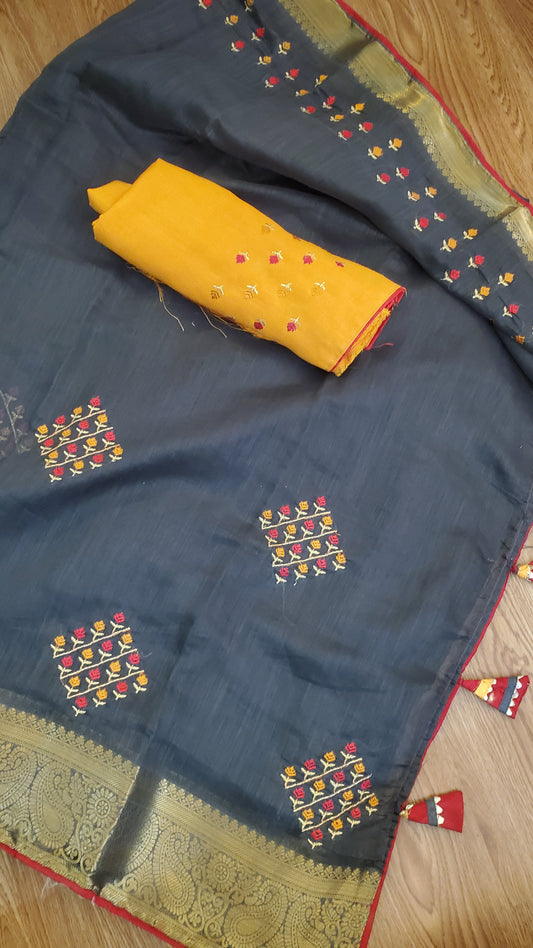 black silk saree with colorful patterns and a yellow color blouse piece