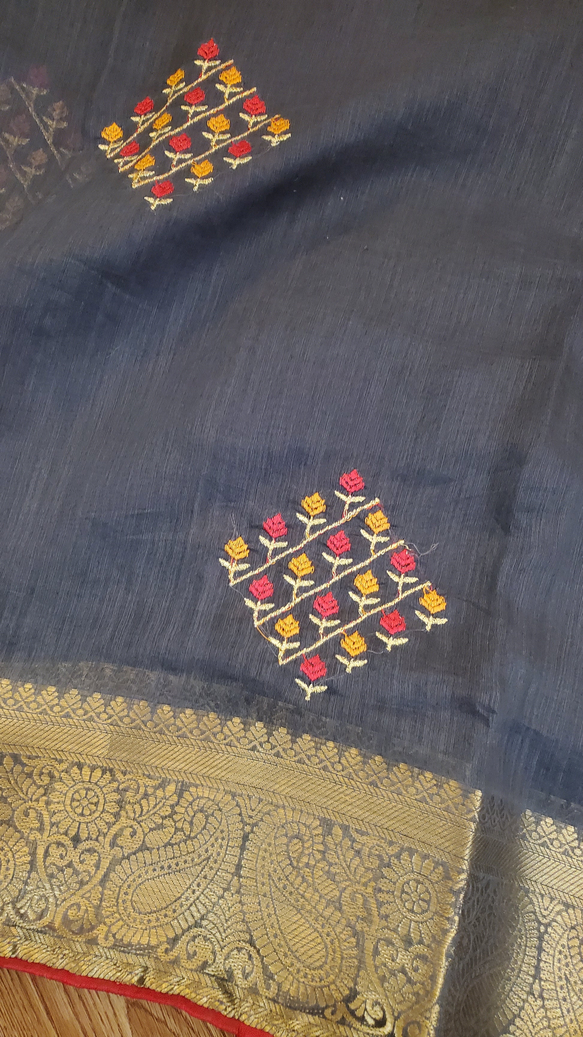 Blue fabric with floral embroidery and gold border