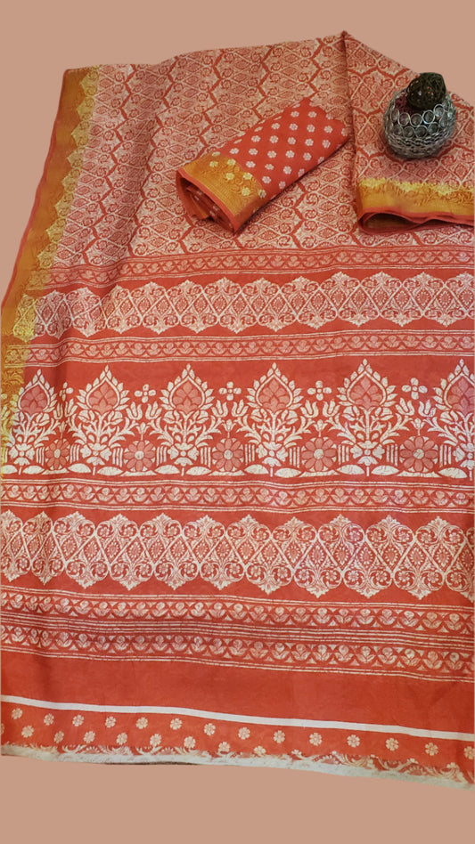 Traditional saree with intricate patterns on a wooden surface