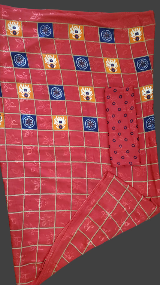 Red checkered fabric with patterned squares on a wooden surface